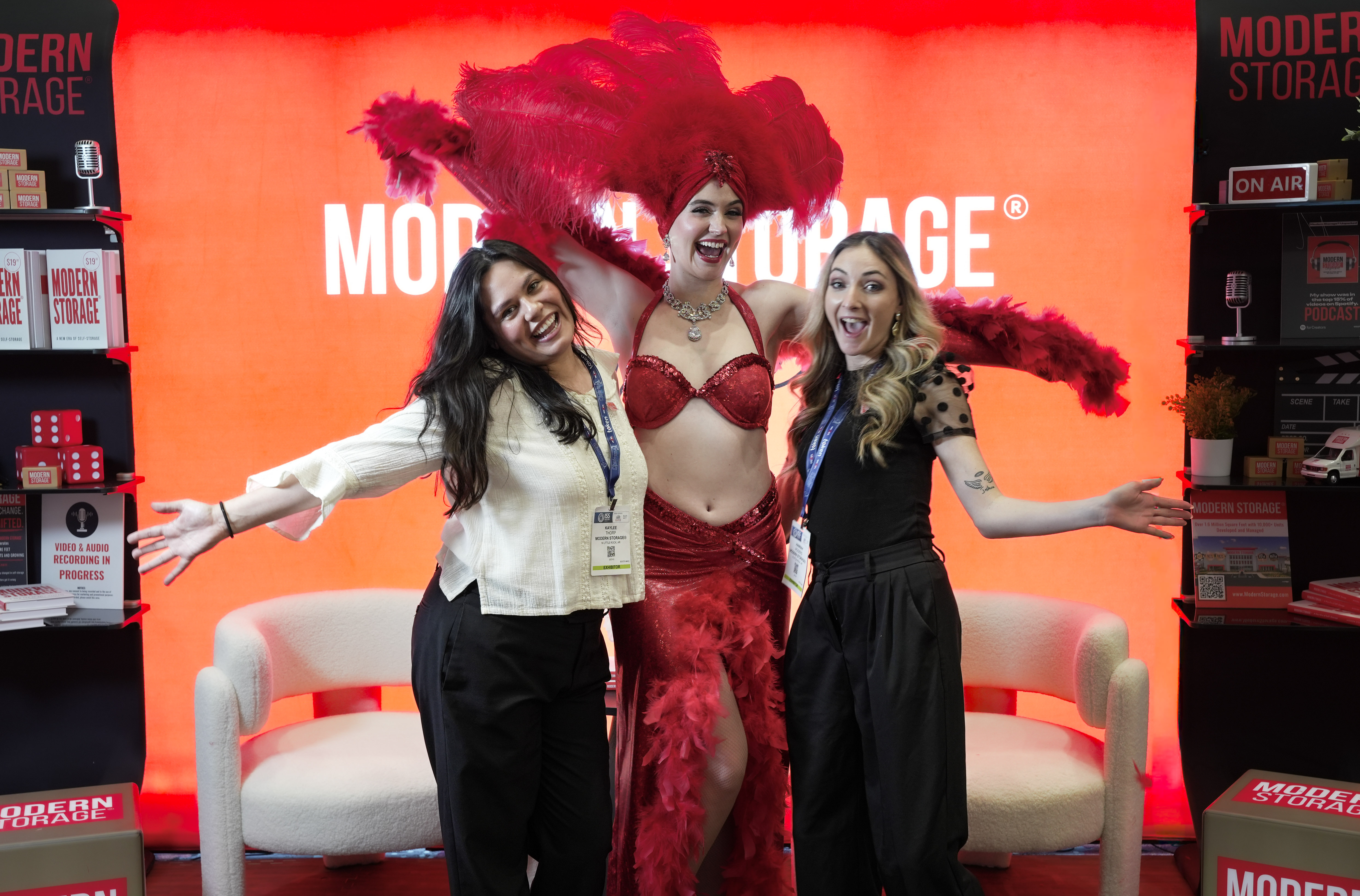 Modern Storage® representatives smiling with a red-costumed performer at the company’s branded expo booth during ISS World Expo 2026